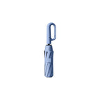 Carabiner handle folding umbrellas in cream white, black and mist blue, custom branded bulk merch by Wumble Merch Australia