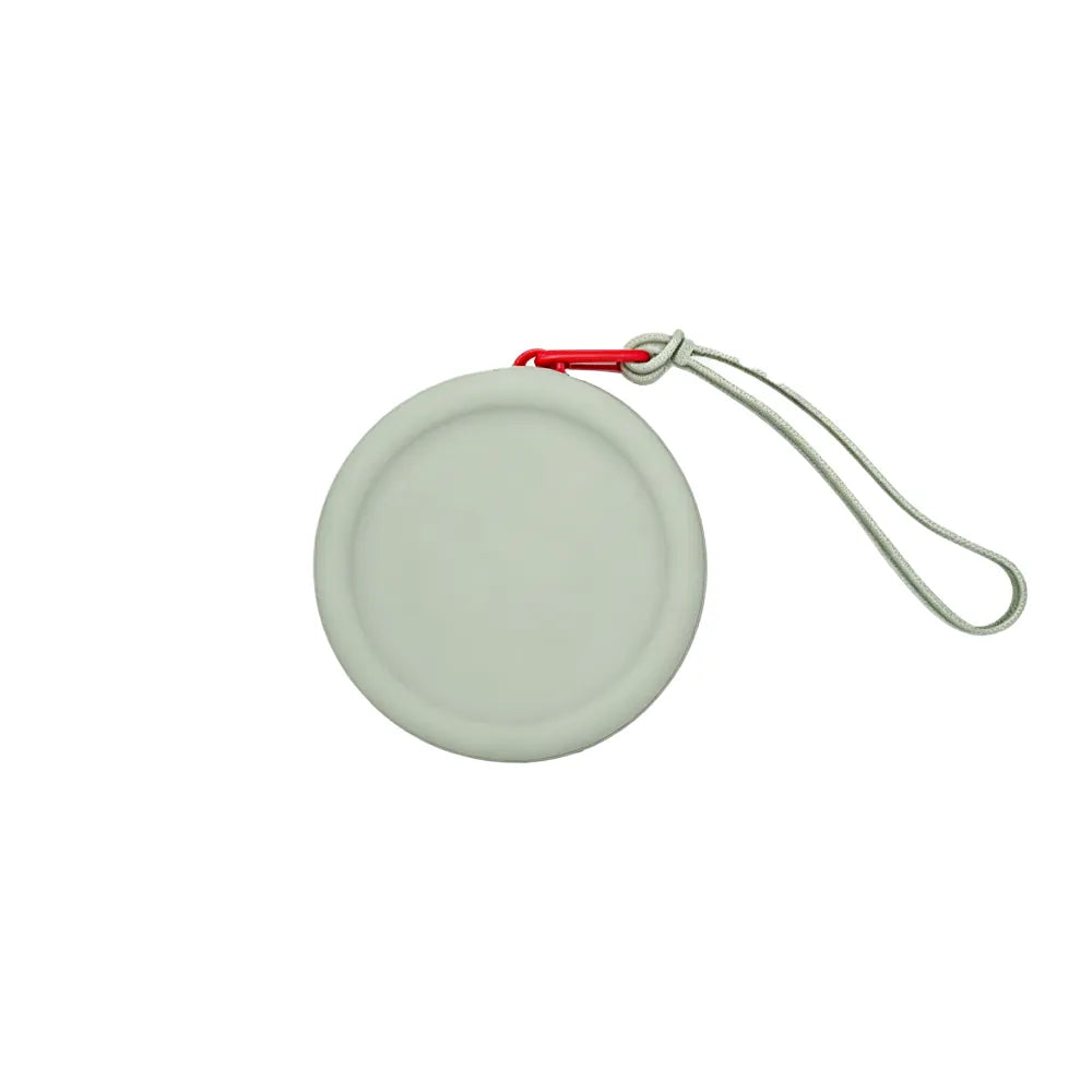 Custom branded round silicone cable pouch in sage grey with orange zipper, bulk tech merch Australia by Wumble