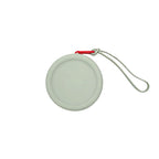 Custom branded round silicone cable pouch in sage grey with orange zipper, bulk tech merch Australia by Wumble