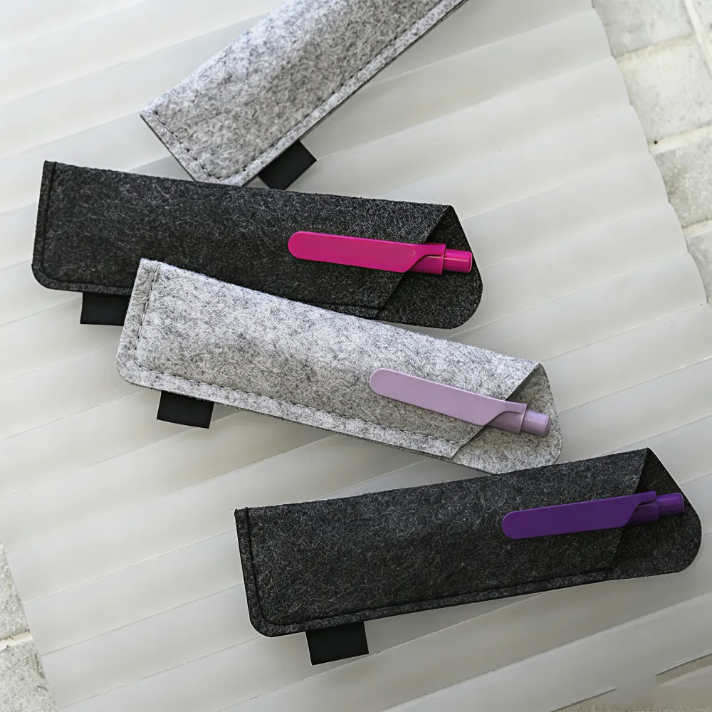 Pen being inserted into custom branded RPET felt pen sleeve, welcome kit merch by Wumble Merch Australia