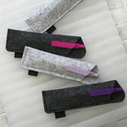 Pen being inserted into custom branded RPET felt pen sleeve, welcome kit merch by Wumble Merch Australia
